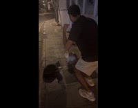 Guy plays music to stop cat fight