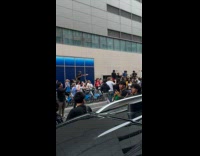 Car bumping rioting people 