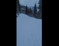 Person skiing mountain follow behind running goat