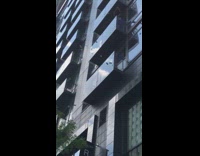 Guy makes it rain and throws dollar bills off balcony in apartment