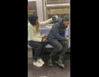Woman massages guys back on the subway 