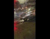 Car drives off street stuck block sidewalk 