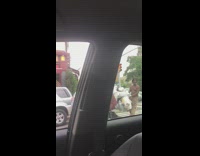 Shirtless guy has two full shopping carts 