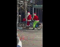 Guys wears santa and the grinch costume 