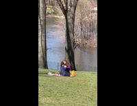 Couple make out on park grass