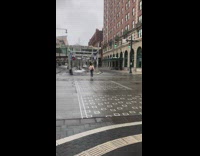 Guy sits on ground to take photo 