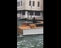 woman white venice canal boat hand up