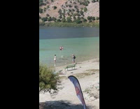 Woman in white dress yoga pose on the beach