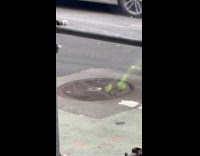 Green flames seen emerge from sewer lid