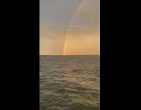 Collab DailyDoseOfInternet - Rainbow arc at the ocean during sunset
