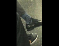 man wearing blue john f kennedy socks on train