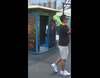 Man hold yoshi plushy on shoulders theme park