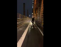 Guy rides bicycle office chair on back 