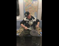 Pt. 2 Guy plays drums with drum pad on his lap on the subway camouflage shorts