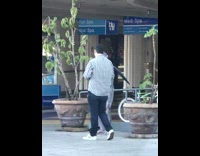 Gargoyle costume guy black wings poses sidewalk 