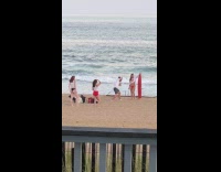 Women poses with red surfboard at beach Part 1