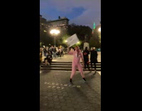 Guy on street holding sign giving pedestrians compliments