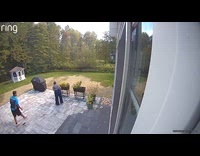 Delivery man uses water hose of filmer