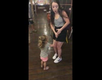 Little girl unzips front zipper black skirt 