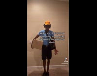 Guy in blue shirt orange hat with package 