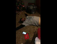 man in grey passed out by christmas tree