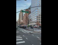 Group of people driving four wheelers down street