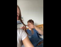 Man braiding girlfriends hair