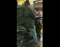 Food delivery courier rides subway on scooter bike