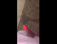 Man red shoes yells at homeless man sleeping on cardboard box to wake up