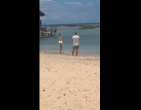 Woman white bikini walks at the beach