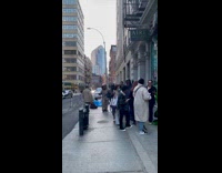 Two men vintage diving suit wait outside store