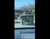 Soldiers riding in an army jeep car on the freeway 
