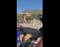 Bikini girl sits splash pad water stroller 