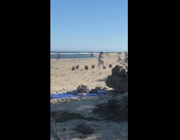 Woman weird dance tree logs video shoot beach