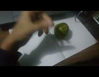 Guy draws on green line black pen