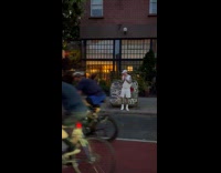 Man poses beside vandalized mailbox on street
