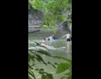 People swim on drawing object in river 