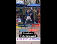 Guy doing funny dance in performance with trombone