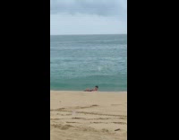 Guy gets pushed by wave while posing 