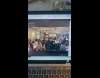 Guy face is big in company group photo