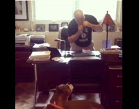 Man plays harmonica and dog howls along