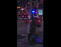 Shirtless guy stands on sidewalk times square 
