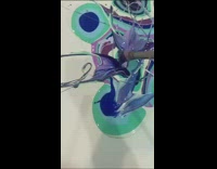 Lady spins canvas to create abstract painting 