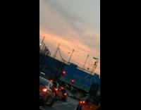 Person on trapeze seen in font of sunset