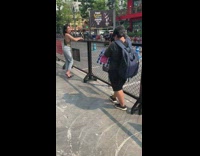 Girl stands next to gate