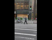 Guy dressed as Trump directs traffic next to hotel 