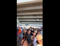 Men retrieving fallen phone underneath yankee stadium