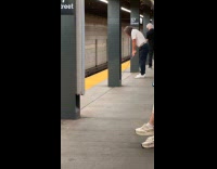 Man swing golf club at subway platform