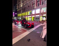 Guy two girls dance crosswalk red car