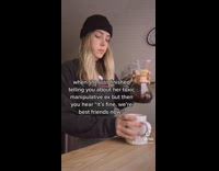 irl pouring coffee stops and looks at camera 